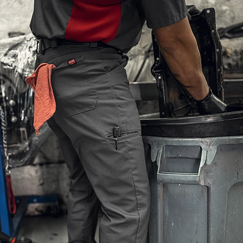 Mechanic with red shop towel hanging out of shorts pocket
