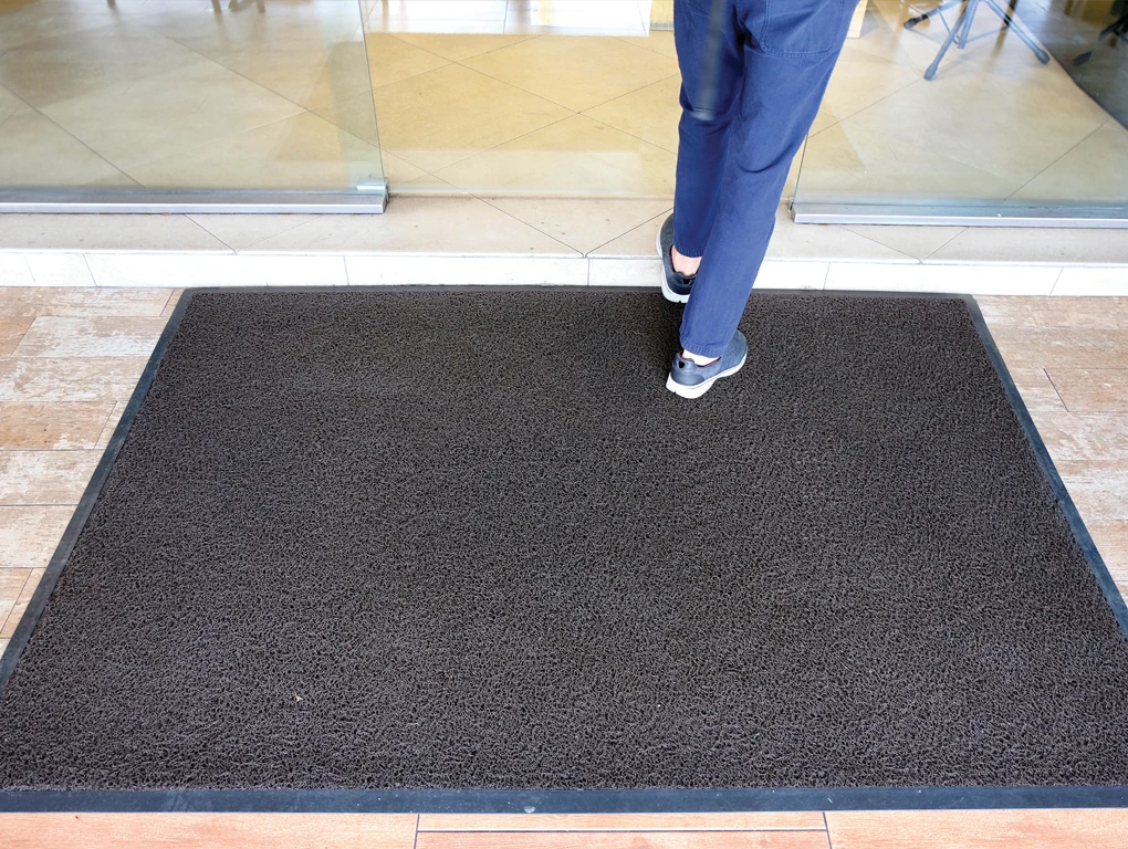 Floor Mat Rentals - Entryway floor mat with person walking into building