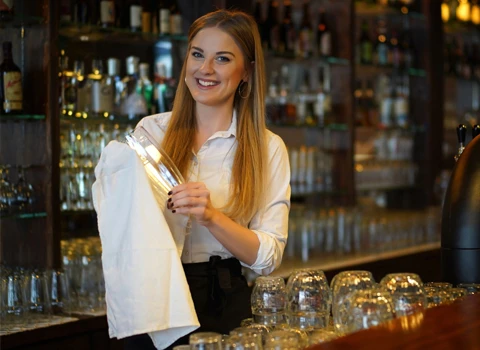 Towel Rental Service - Bartender cleaning bar glasses with white kitchen towel