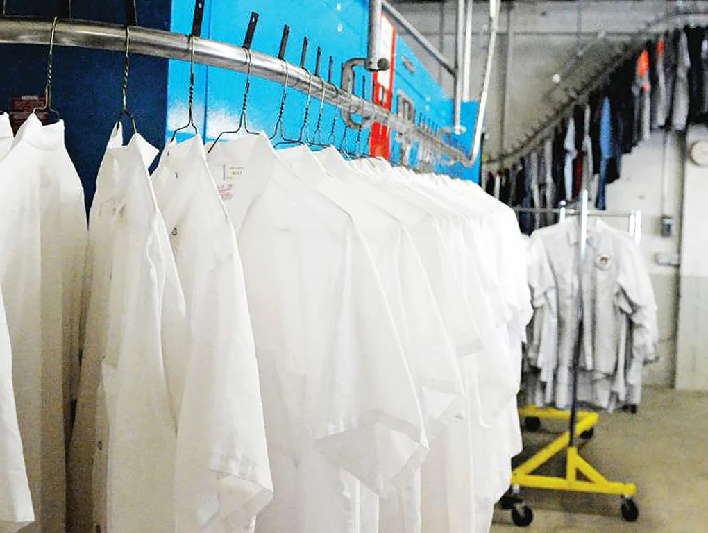 Oregon Linen & Uniform, Uniforms hung up on rack 