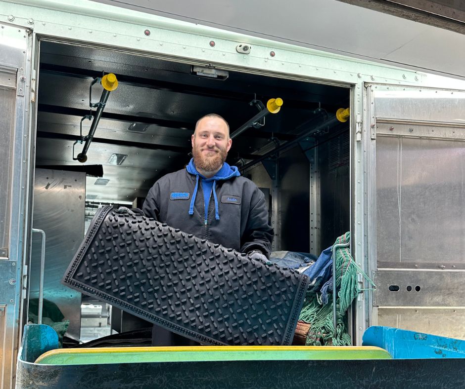 employee with mat oregon linen employee with a floor mat