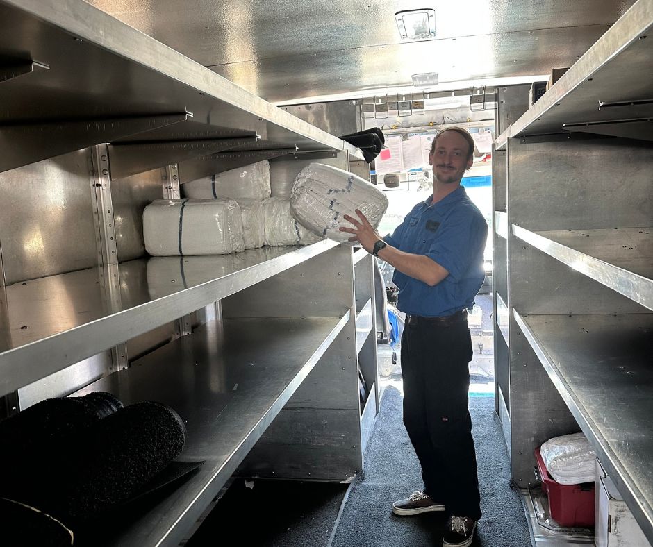 Oregon linen employee with folded towels